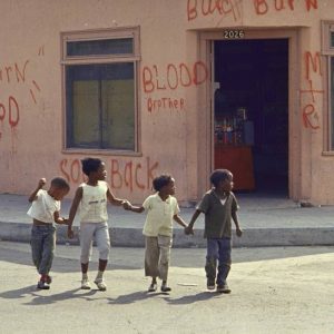 Caption from LIFE. "Children in Watts grow up with the signs of fear, desperation and hatred all around. The words painted last August on this little grocery store, telling rioters that it is owned by a Negro and urging them to burn something else, were left on the walls for months afterwards -- just in case."